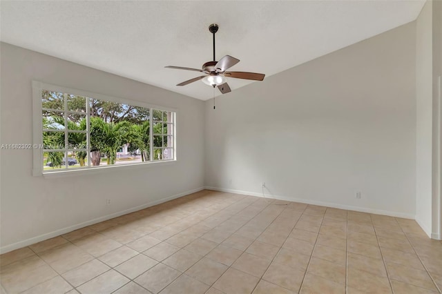 spare room with vaulted ceiling, ceiling fan, and light tile patterned flooring