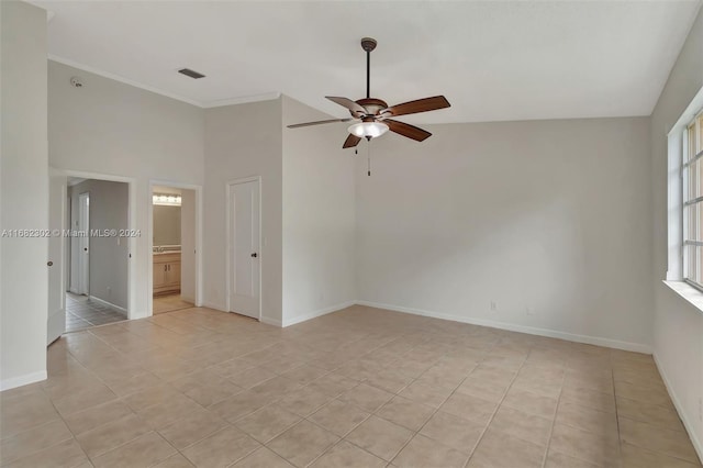 spare room featuring light tile patterned floors, plenty of natural light, ceiling fan, and crown molding