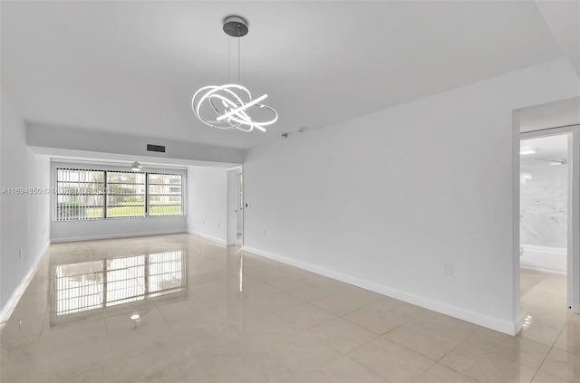 spare room with light tile patterned floors and a notable chandelier