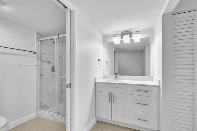 bathroom featuring a shower with shower door, vanity, and toilet