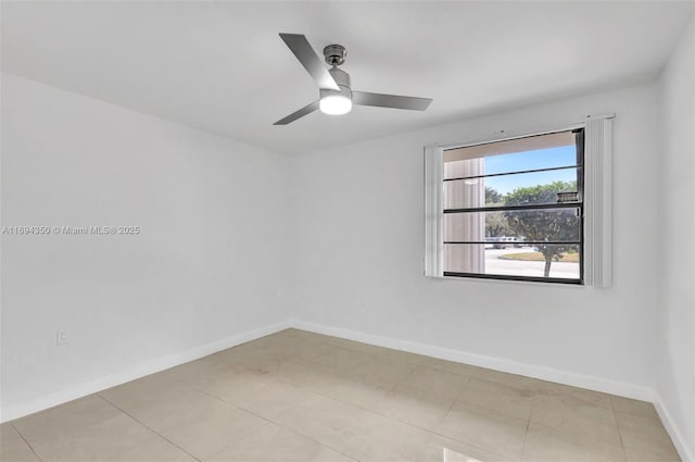 tiled empty room featuring ceiling fan