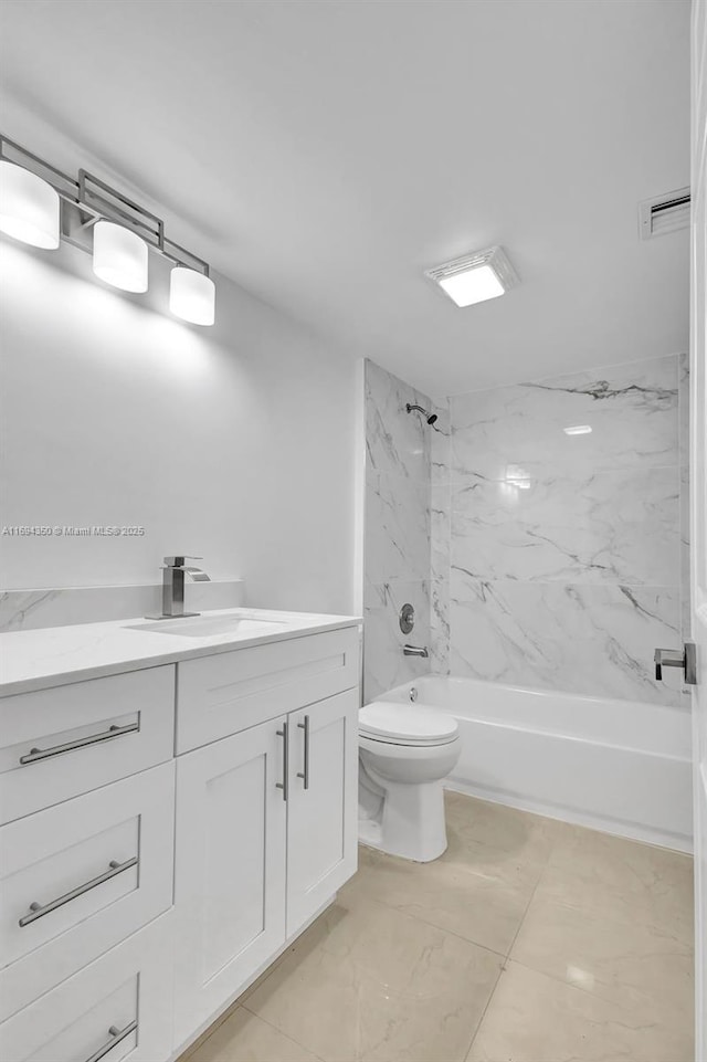 full bathroom with toilet, tiled shower / bath, and vanity