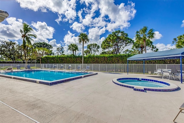 view of pool featuring a patio area and a community hot tub