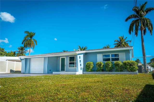 single story home with a front lawn and a garage