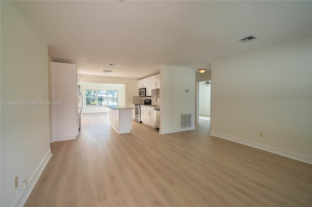 unfurnished living room featuring light hardwood / wood-style floors