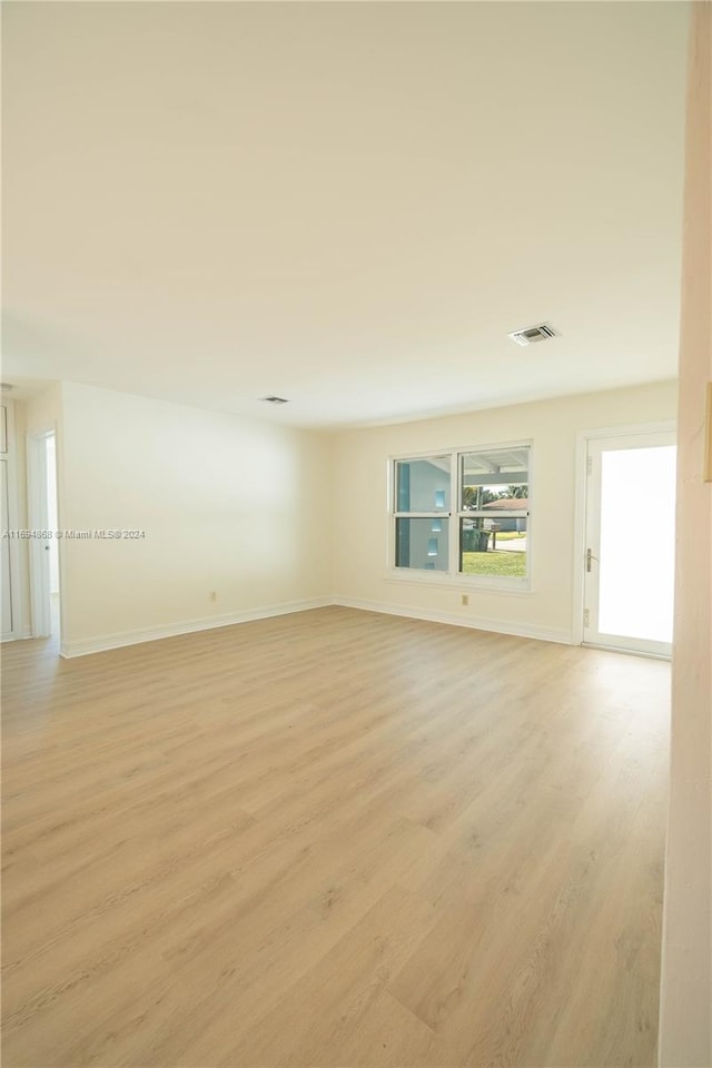 spare room featuring light wood-type flooring