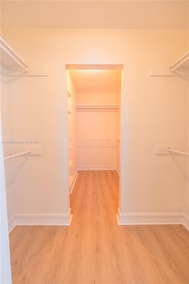 4450 SW 34th Dr, Dania Beach, FL 33312 - walk in closet featuring wood finished floors