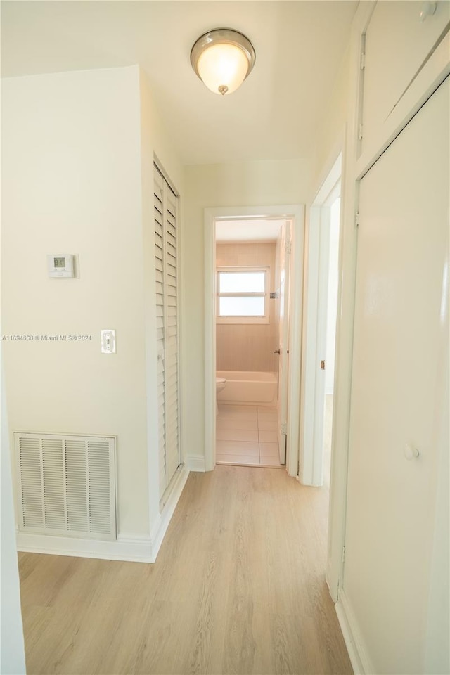 4450 SW 34th Dr, Dania Beach, FL 33312 - corridor featuring light wood-style floors and baseboards