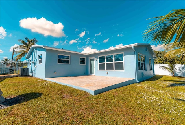 rear view of house featuring a yard and central AC