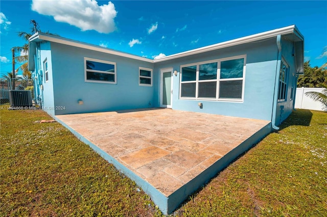 4450 SW 34th Dr, Dania Beach, FL 33312 - back of house with stucco siding, a patio area, and central air condition unit