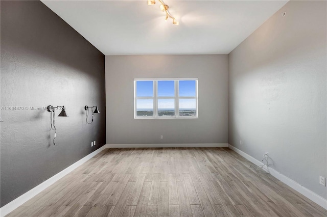 spare room with light hardwood / wood-style floors