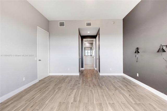 unfurnished room with light hardwood / wood-style floors