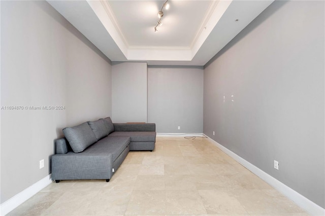 living area featuring crown molding and a tray ceiling