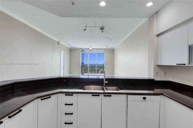 kitchen featuring white cabinetry, sink, white dishwasher, dark stone counters, and ornamental molding