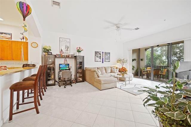 tiled living room with ceiling fan