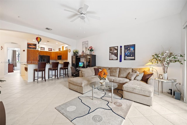 living room featuring light tile patterned floors and ceiling fan