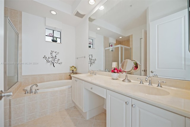 bathroom featuring plus walk in shower, vanity, and tile patterned floors