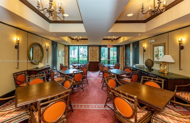 dining room featuring a raised ceiling and ornamental molding