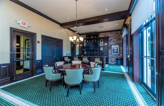 dining room featuring beamed ceiling, an inviting chandelier, and ornamental molding