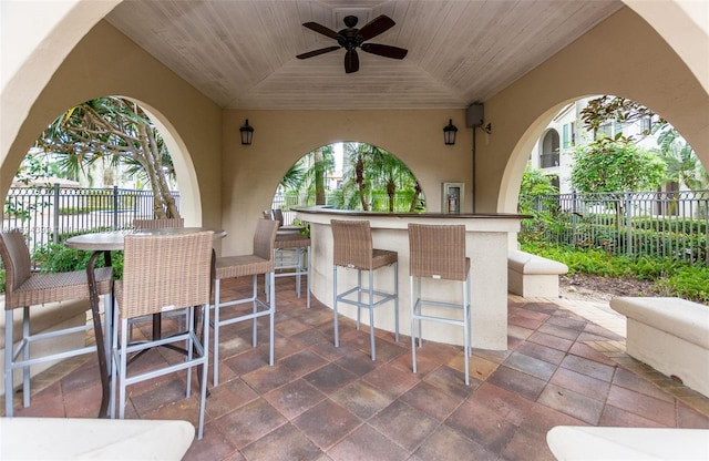 view of patio / terrace featuring ceiling fan and an outdoor bar