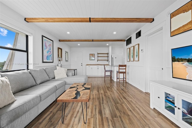 living room with beam ceiling, hardwood / wood-style flooring, and wooden ceiling