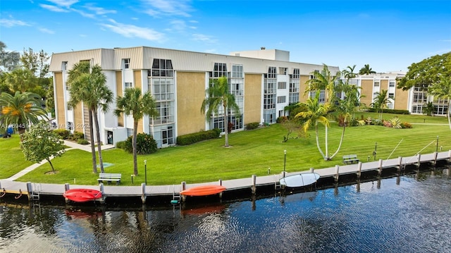 dock area with a yard and a water view