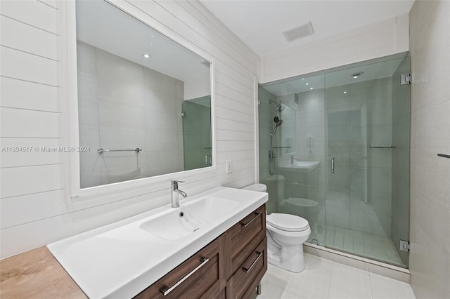 bathroom featuring tile patterned floors, vanity, toilet, and walk in shower