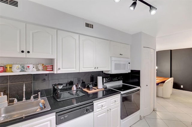 kitchen featuring white cabinets, white appliances, sink, and light tile patterned floors