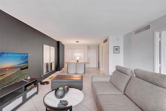 living room featuring light tile patterned flooring and a textured ceiling