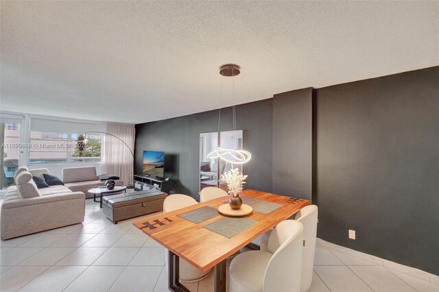 6770 Indian Creek Dr Unit 4R, Miami Beach, FL 33141 - dining room featuring a chandelier, a textured ceiling, and light tile patterned flooring