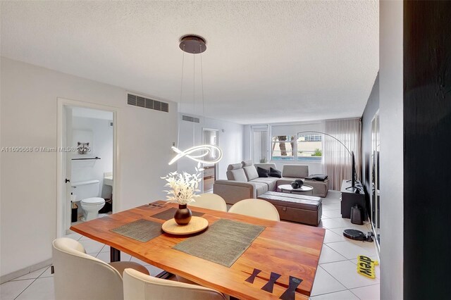 6770 Indian Creek Dr Unit 4R, Miami Beach, FL 33141 - dining area with a textured ceiling, visible vents, and light tile patterned floors