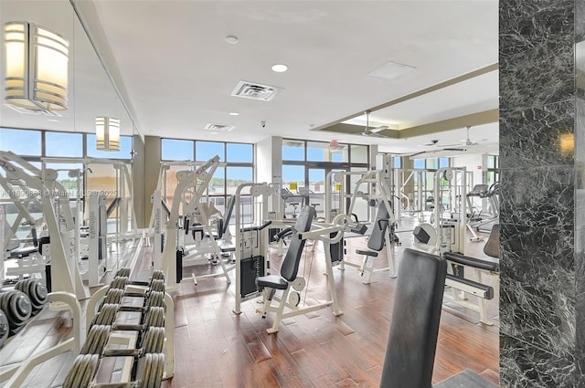 6770 Indian Creek Dr Unit 4R, Miami Beach, FL 33141 - gym featuring a healthy amount of sunlight, wood finished floors, visible vents, and floor to ceiling windows