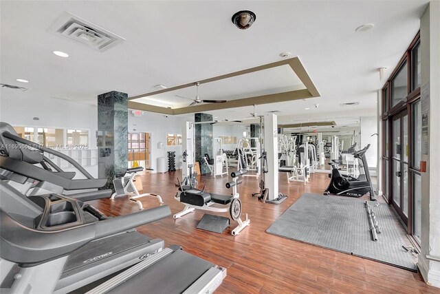 6770 Indian Creek Dr Unit 4R, Miami Beach, FL 33141 - gym with wood finished floors, visible vents, ceiling fan, and a tray ceiling