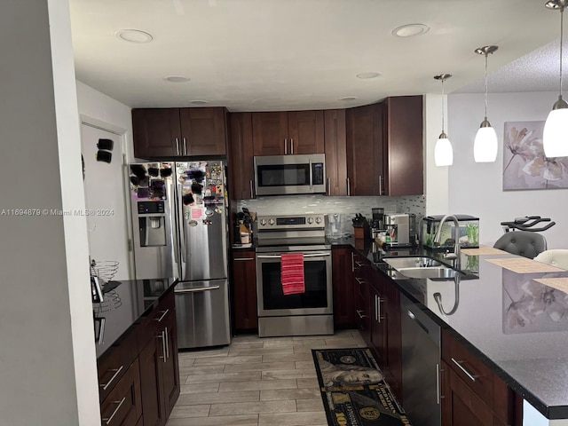 kitchen with sink, hanging light fixtures, tasteful backsplash, light hardwood / wood-style floors, and stainless steel appliances