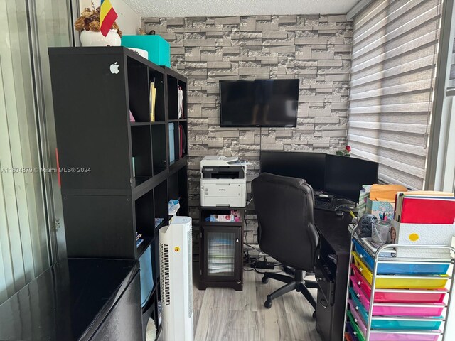 office space with a textured ceiling and hardwood / wood-style flooring