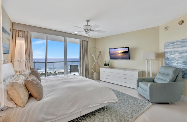 bedroom with access to exterior, ceiling fan, and light tile patterned floors