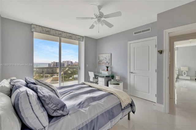 tiled bedroom featuring ceiling fan