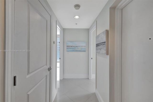 corridor with light tile patterned floors