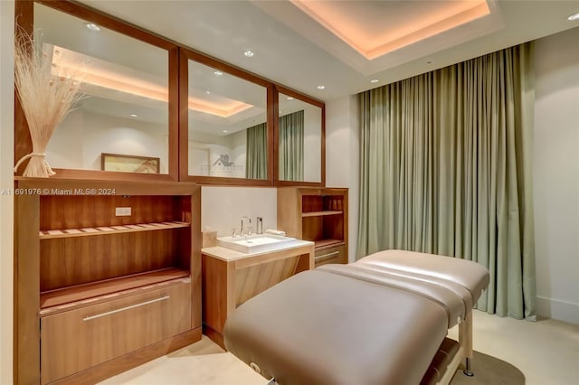 bathroom featuring a raised ceiling and vanity