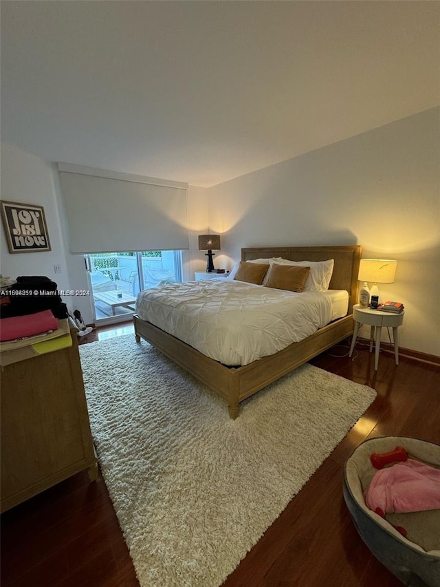 bedroom featuring access to outside and dark hardwood / wood-style floors