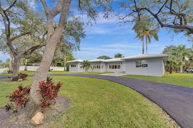 ranch-style home with a front lawn