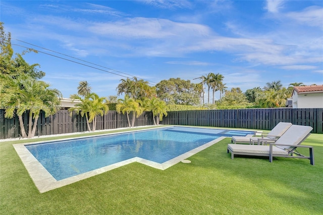 view of pool with a lawn