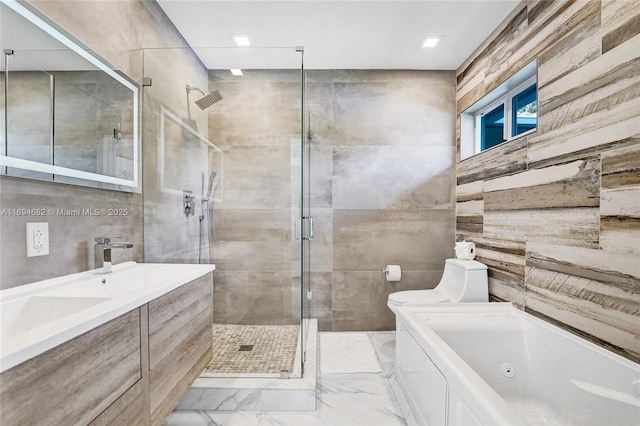 full bathroom featuring independent shower and bath, vanity, and tile walls