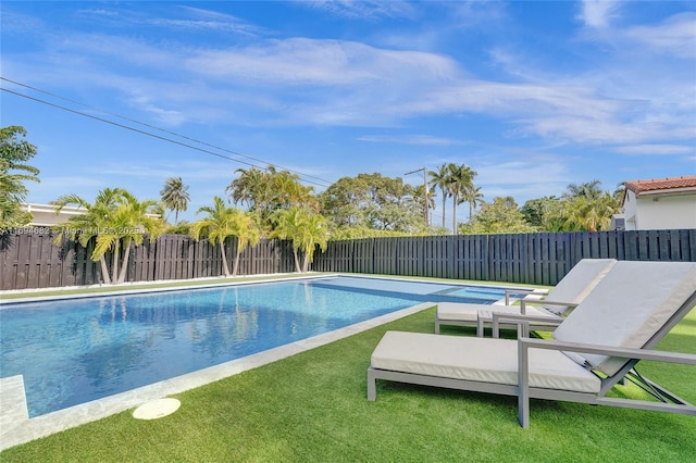 view of pool with a lawn