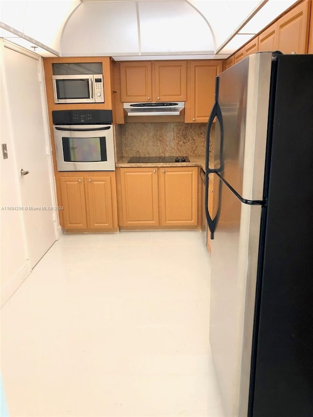 3901 S Ocean Dr Unit 2J, Hollywood, FL 33019 - kitchen with appliances with stainless steel finishes, under cabinet range hood, and backsplash