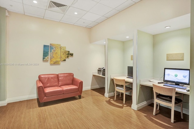 office space featuring a drop ceiling and wood-type flooring