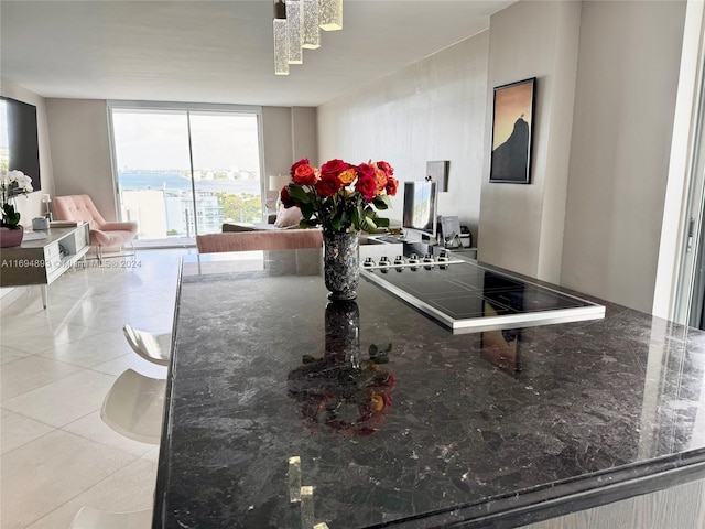 kitchen with light tile patterned flooring and dark stone counters