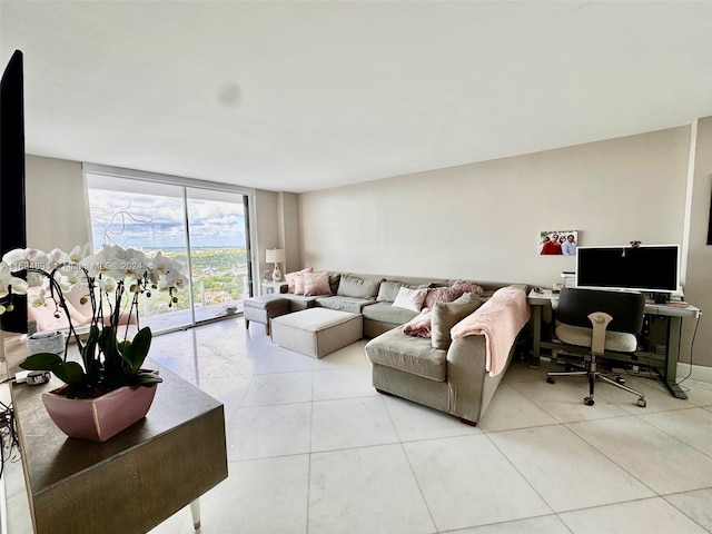 living room with light tile patterned floors and floor to ceiling windows