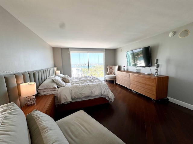 bedroom with dark wood-type flooring