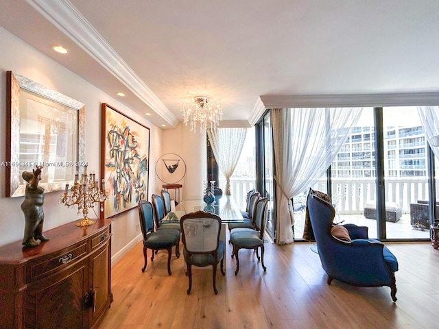 dining area featuring a chandelier, light hardwood / wood-style floors, and crown molding